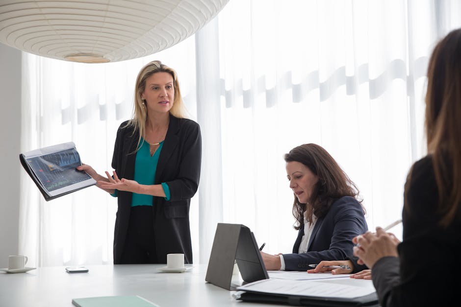 Businesswoman presenting data during an indoor corporate meeting.
